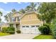 Beautifully landscaped two-story home with a two-car garage and a well-maintained front yard at 188 Donning Dr, Summerville, SC 29483