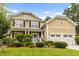 Attractive two-story home with a two-car garage, lush landscaping, and a welcoming front porch at 188 Donning Dr, Summerville, SC 29483