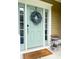 Charming home featuring a light-blue front door, decorative wreath, and a 'Welcome' mat for a warm invitation at 188 Donning Dr, Summerville, SC 29483