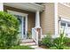 Close up of a charming front porch with a welcoming entrance, and beautifully landscaped garden at 188 Donning Dr, Summerville, SC 29483