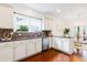 Bright kitchen featuring granite countertops, white cabinetry, stainless dishwasher, and hardwood flooring at 188 Donning Dr, Summerville, SC 29483