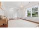 Open living room featuring detailed trim work, wood floors, and an abundance of natural light from a large window at 188 Donning Dr, Summerville, SC 29483