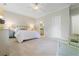 Bright main bedroom with neutral tones, plush carpet, and a glimpse of the en-suite bathroom at 188 Donning Dr, Summerville, SC 29483
