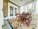 Covered porch with table, chairs, and a colorful rug at 188 Donning Dr, Summerville, SC 29483