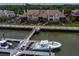Beautiful aerial view of a boat docked along waterfront townhomes, offering a serene coastal lifestyle at 1919 Marsh Oak Ln, Seabrook Island, SC 29455
