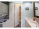 A bathroom with a stackable washer and dryer and an adjacent shower/tub combo at 1919 Marsh Oak Ln, Seabrook Island, SC 29455
