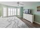The bright bedroom showcases a flat-screen TV and abundant natural light at 1919 Marsh Oak Ln, Seabrook Island, SC 29455