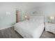 Bright bedroom showcasing a large white bed with storage, complemented by matching nightstands and calming decor at 1919 Marsh Oak Ln, Seabrook Island, SC 29455
