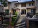 Exterior view of a multi-story condo building featuring stairs to the units and mature landscaping at 1919 Marsh Oak Ln, Seabrook Island, SC 29455