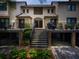 Exterior view of a multi-story condo building featuring stairs to the units and mature landscaping at 1919 Marsh Oak Ln, Seabrook Island, SC 29455