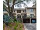 Exterior view of a multi-story condo building featuring covered parking, stairs to the units, and mature landscaping at 1919 Marsh Oak Ln, Seabrook Island, SC 29455