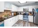 Well-organized kitchen with white cabinets, granite countertops, stainless steel appliances, and tile backsplash at 1919 Marsh Oak Ln, Seabrook Island, SC 29455