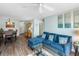 Living room featuring a comfortable blue sectional sofa, dining area, and neutral paint at 1919 Marsh Oak Ln, Seabrook Island, SC 29455