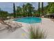 Inviting pool area with several lounge chairs perfect for relaxing, set against a backdrop of lush greenery at 1919 Marsh Oak Ln, Seabrook Island, SC 29455