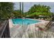 Beautiful community pool with lounge chairs, palm trees, and meticulously maintained landscaping at 1919 Marsh Oak Ln, Seabrook Island, SC 29455