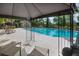 Relaxing pool with lounge chairs, shaded seating, and a view of surrounding trees and community buildings at 1919 Marsh Oak Ln, Seabrook Island, SC 29455
