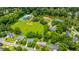 Aerial view showcases homes, lake, community center, and mature trees at 2026 Thornhill Dr, Summerville, SC 29485