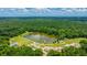A scenic aerial view of the community lake, pathways, and picnic areas surrounded by lush greenery at 2026 Thornhill Dr, Summerville, SC 29485