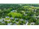 An aerial view showing the community pool and the serene lake surrounded by mature trees and well-kept homes at 2026 Thornhill Dr, Summerville, SC 29485