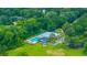 Overhead view of the community pool, tennis courts, and clubhouse surrounded by verdant trees at 2026 Thornhill Dr, Summerville, SC 29485
