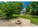 A backyard features a shed, fire pit, and lush green landscaping at 2026 Thornhill Dr, Summerville, SC 29485