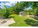 Well-manicured backyard featuring a storage shed, patio area with fire pit, lawn and privacy fence at 2026 Thornhill Dr, Summerville, SC 29485
