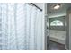 Bright bathroom featuring a shower with white curtain and separate soaking tub at 2026 Thornhill Dr, Summerville, SC 29485