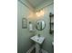 Powder room with vessel sink, round mirror, and painted walls at 2026 Thornhill Dr, Summerville, SC 29485