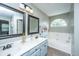 Bathroom featuring double vanity, large mirrors and a garden tub at 2026 Thornhill Dr, Summerville, SC 29485