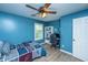 Blue bedroom featuring a comfortable bed, built in shelves, a computer workstation and window at 2026 Thornhill Dr, Summerville, SC 29485