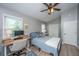 Bright bedroom featuring ceiling fan, desk, hardwood floors, and natural light at 2026 Thornhill Dr, Summerville, SC 29485