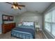 Vaulted ceiling bedroom with black iron bed frame, wood floors, and paneled walls at 2026 Thornhill Dr, Summerville, SC 29485