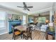 Cozy dining area featuring blue fireplace, wood floors, and open layout to a living area at 2026 Thornhill Dr, Summerville, SC 29485
