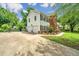 Long driveway leading to a two-car garage and a basketball hoop, surrounded by lush greenery at 2026 Thornhill Dr, Summerville, SC 29485