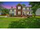 Charming two-story home with a lush green lawn and colorful flowerbeds at dusk at 2026 Thornhill Dr, Summerville, SC 29485