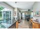 Open kitchen with dark countertops, stainless steel appliances, and open view to a sunroom and dining area at 2026 Thornhill Dr, Summerville, SC 29485