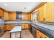 Spacious kitchen with light wood cabinets, granite countertops, tile backsplash, and center island with seating at 2026 Thornhill Dr, Summerville, SC 29485
