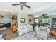Open-concept living room with ceiling fan, white couch, and hardwood flooring at 2026 Thornhill Dr, Summerville, SC 29485