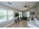 Bright living room with wood flooring, a ceiling fan, and plenty of natural light at 2026 Thornhill Dr, Summerville, SC 29485