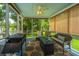 Inviting screened porch with grill, ceiling fan and fire pit with outdoor seating at 2026 Thornhill Dr, Summerville, SC 29485