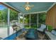 This screened porch has a ceiling fan and outdoor seating with a view of the yard at 2026 Thornhill Dr, Summerville, SC 29485