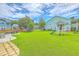 Green backyard with patio area, play equipment, and a trampoline at 207 Center Hill Ct, Summerville, SC 29485