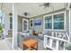 Relaxing covered patio with comfortable seating, a swing, and a mounted TV at 207 Center Hill Ct, Summerville, SC 29485