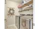 Bright laundry room featuring a stainless steel washer and dryer and wooden shelving at 207 Center Hill Ct, Summerville, SC 29485