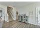 Living room showcasing a staircase and a decorative cabinet with glass doors, offering ample storage space at 207 Center Hill Ct, Summerville, SC 29485