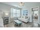 Bright main bedroom sitting area with hardwood floors, white sofa and ocean artwork at 207 Center Hill Ct, Summerville, SC 29485