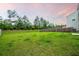 Large, lush backyard with green grass and a wooden fence, perfect for outdoor activities at 209 Hayworth Rd, Summerville, SC 29486