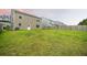 Expansive backyard with lush green grass, trees, and a wooden fence, offering plenty of space and privacy at 209 Hayworth Rd, Summerville, SC 29486