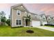 A two-story home with a two-car garage, manicured lawn, and mature landscaping at 209 Hayworth Rd, Summerville, SC 29486