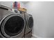 Modern laundry room featuring a washer and dryer and storage shelves above at 209 Hayworth Rd, Summerville, SC 29486